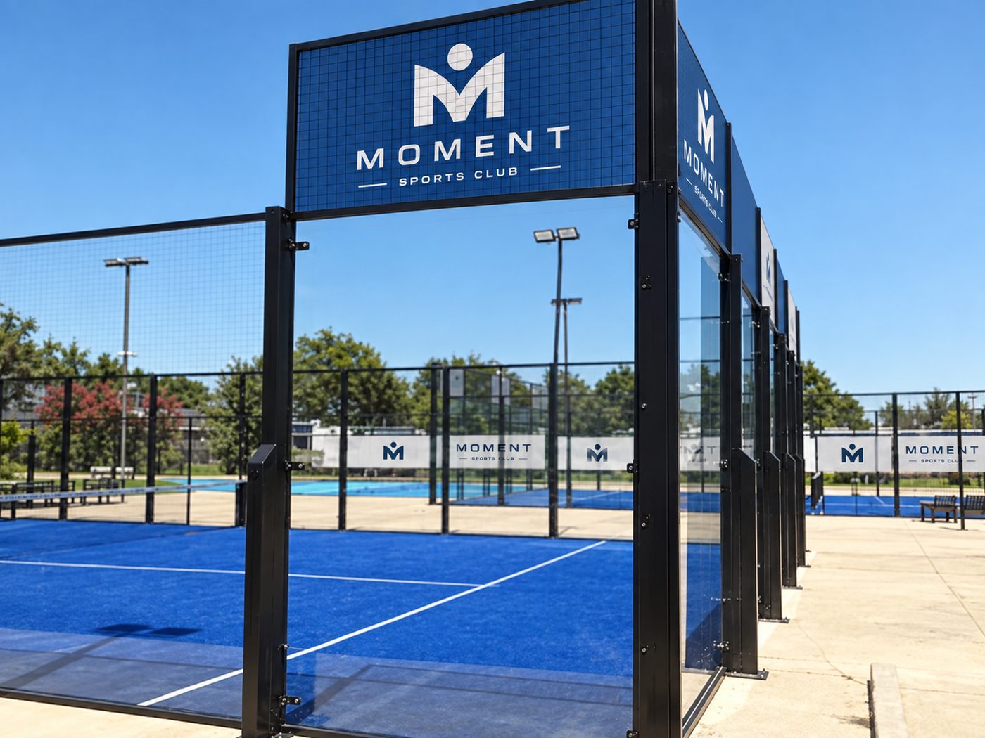 Outdoor Moment padel courts under a clear sky