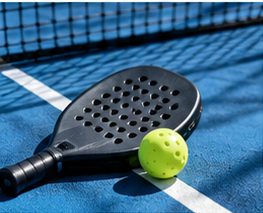 Paddle and ball on a blue court